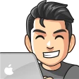 Cartoon avatar grinning behind a laptop